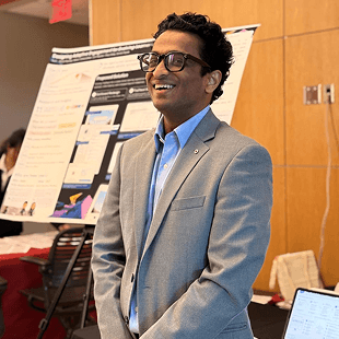 Cyril in a blazer at a conference